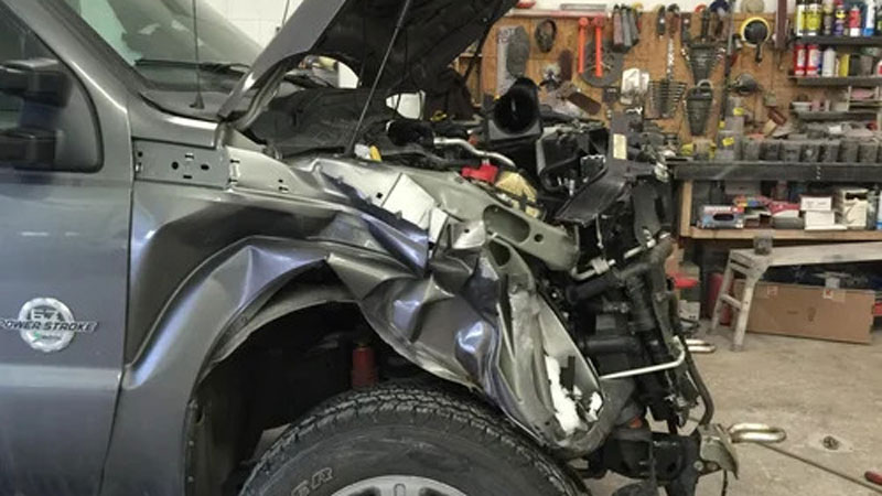 A truck with a lot of impact damage on the front
