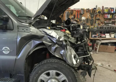 Ford Truck with a smashed in front end after a collision